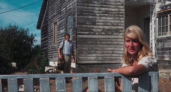 Movie still from “Smooth Talk” (1985), directed by Joyce Chopra – A man and a woman standing in front of a house; Medium shot, Low angle