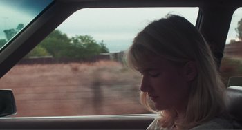 Movie still from “Smooth Talk” (1985), directed by Joyce Chopra – A woman sitting in the back of a car looking out the window; Close Up shot, Low angle