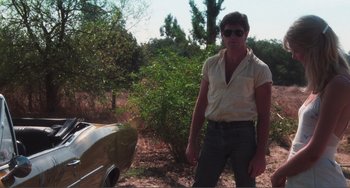 Movie still from “Smooth Talk” (1985), directed by Joyce Chopra – A man standing next to a boat in a field; Medium shot, Low angle