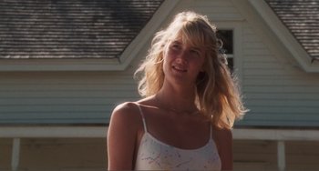 Movie still from “Smooth Talk” (1985), directed by Joyce Chopra – A young blonde woman in a tank top smiling; Close Up shot, Low angle