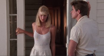 Movie still from “Smooth Talk” (1985), directed by Joyce Chopra – A man and a woman standing next to each other; Medium shot, Low angle