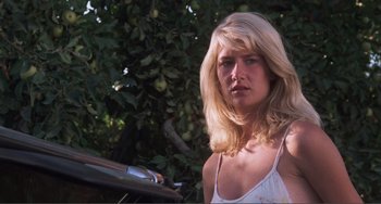 Movie still from “Smooth Talk” (1985), directed by Joyce Chopra – A woman with long blonde hair standing in front of an apple tree; Close Up shot, Low angle