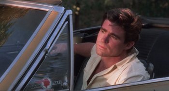 Movie still from “Smooth Talk” (1985), directed by Joyce Chopra – A man sitting in the driver's seat of a car; Close Up shot, Low angle