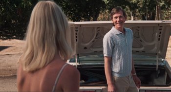 Movie still from “Smooth Talk” (1985), directed by Joyce Chopra – A man and a woman standing in front of an open trunk of a car; Medium shot, Over the shoulder angle
