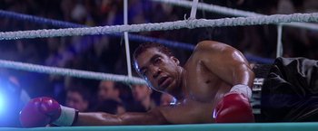 Movie still from “Snake Eyes” (1998), directed by Brian De Palma – A man in a boxing ring getting ready for a fight; Medium shot, Low angle