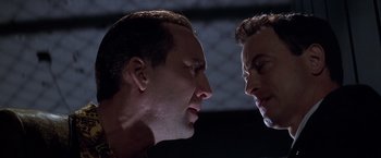 Movie still from “Snake Eyes” (1998), directed by Brian De Palma – Two men face to face in a dark room; Close Up shot, Low angle