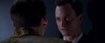 Movie still from “Snake Eyes” (1998), directed by Brian De Palma – A man looking at himself in the mirror; Close Up shot, Over the shoulder angle