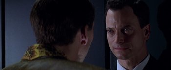 Movie still from “Snake Eyes” (1998), directed by Brian De Palma – A man looking at himself in the mirror; Close Up shot, Over the shoulder angle