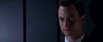 Movie still from “Snake Eyes” (1998), directed by Brian De Palma – A man's face in front of a mirror; Close Up shot, Low angle