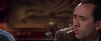 Movie still from “Snake Eyes” (1998), directed by Brian De Palma – A cigarette on a couch; Close Up shot, Low angle