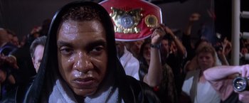 Movie still from “Snake Eyes” (1998), directed by Brian De Palma – A person wearing a boxing hood; Close Up shot, Low angle