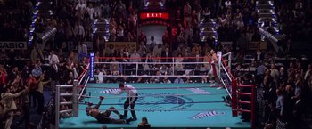 Movie still from “Snake Eyes” (1998), directed by Brian De Palma – A boxing match in a boxing ring in front of an audience; Extreme Wide shot, Overhead angle