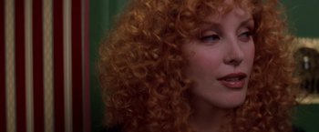 Movie still from “Snake Eyes” (1998), directed by Brian De Palma – A person with curly hair; Close Up shot, Over the shoulder angle