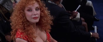 Movie still from “Snake Eyes” (1998), directed by Brian De Palma – A person with long red curly hair; Close Up shot, Over the shoulder angle