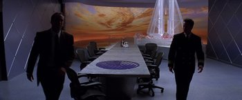 Movie still from “Snake Eyes” (1998), directed by Brian De Palma – A conference table with chairs around it; Extreme Wide shot, High angle