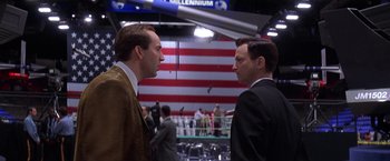 Movie still from “Snake Eyes” (1998), directed by Brian De Palma – Two men in business suits facing one another; Medium shot, Low angle