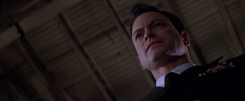 Movie still from “Snake Eyes” (1998), directed by Brian De Palma – A man in a suit and tie; Close Up shot, Low angle