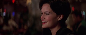 Movie still from “Snake Eyes” (1998), directed by Brian De Palma – A person with a smile on their face; Close Up shot, Over the shoulder angle