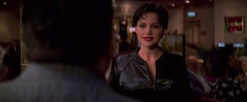 Movie still from “Snake Eyes” (1998), directed by Brian De Palma – A person wearing a leather jacket; Close Up shot, Over the shoulder angle