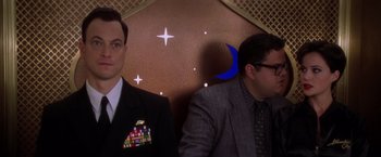 Movie still from “Snake Eyes” (1998), directed by Brian De Palma – Two men in suits and ties standing next to each other; Medium shot, Over the shoulder angle