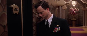 Movie still from “Snake Eyes” (1998), directed by Brian De Palma – A person wearing a suit and tie; Close Up shot, Low angle