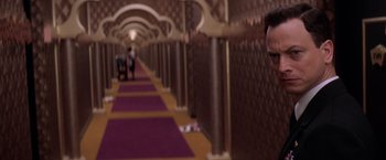 Movie still from “Snake Eyes” (1998), directed by Brian De Palma – People walking in a long hallway with purple carpet; Close Up shot, Over the shoulder angle