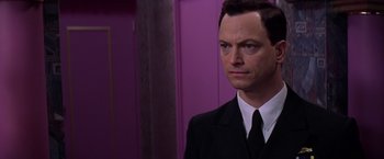 Movie still from “Snake Eyes” (1998), directed by Brian De Palma – A person wearing a suit and tie; Close Up shot, Over the shoulder angle