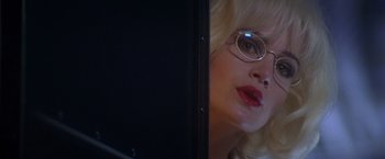 Movie still from “Snake Eyes” (1998), directed by Brian De Palma – A woman with glasses looking at a monitor; Close Up shot, Over the shoulder angle