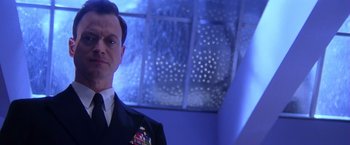 Movie still from “Snake Eyes” (1998), directed by Brian De Palma – A person wearing a suit and tie; Close Up shot, Low angle