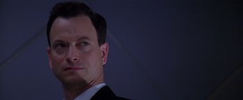 Movie still from “Snake Eyes” (1998), directed by Brian De Palma – A person wearing a suit and tie; Close Up shot, Low angle