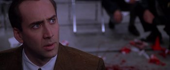 Movie still from “Snake Eyes” (1998), directed by Brian De Palma – A person wearing a suit and tie; Close Up shot, Over the shoulder angle