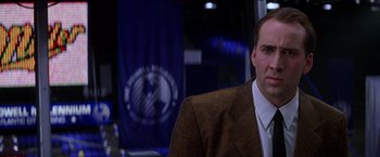 Movie still from “Snake Eyes” (1998), directed by Brian De Palma – A person wearing a suit and tie; Close Up shot, Low angle