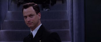 Movie still from “Snake Eyes” (1998), directed by Brian De Palma – A person wearing a suit and tie; Close Up shot, Over the shoulder angle