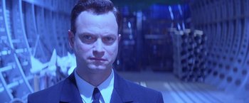 Movie still from “Snake Eyes” (1998), directed by Brian De Palma – A person wearing a suit and tie; Close Up shot, Low angle