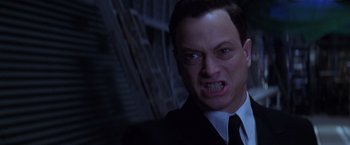 Movie still from “Snake Eyes” (1998), directed by Brian De Palma – A man that is wearing a suit and tie; Close Up shot, Low angle