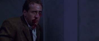 Movie still from “Snake Eyes” (1998), directed by Brian De Palma – A man with blood all over his face; Close Up shot, Low angle
