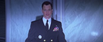 Movie still from “Snake Eyes” (1998), directed by Brian De Palma – A person wearing a suit and tie; Close Up shot, Low angle