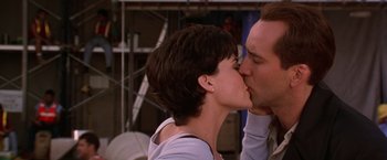 Movie still from “Snake Eyes” (1998), directed by Brian De Palma – A man and a woman kissing each other in a room; Close Up shot, Low angle