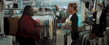 Movie still from “Snatched” (2017), directed by Jonathan Levine – Two women are shopping in a clothing store; Medium shot, Over the shoulder angle