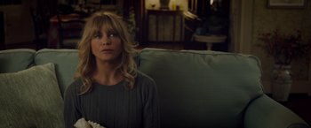 Movie still from “Snatched” (2017), directed by Jonathan Levine – A woman sitting on top of a couch holding a popcorn; Close Up shot, Over the shoulder angle