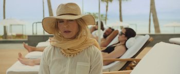 Movie still from “Snatched” (2017), directed by Jonathan Levine – A woman wearing a straw hat and a scarf; Close Up shot, Over the shoulder angle