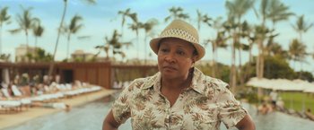 Movie still from “Snatched” (2017), directed by Jonathan Levine – A woman wearing a straw hat and a floral shirt; Close Up shot, Over the shoulder angle