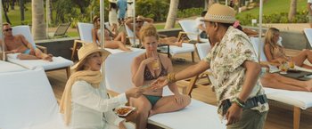 Movie still from “Snatched” (2017), directed by Jonathan Levine – Two women and a man sitting on a lounge chair; Medium shot, Over the shoulder angle