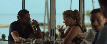Movie still from “Snatched” (2017), directed by Jonathan Levine – Two women sitting at a table with drinks in front of them; Medium shot, Over the shoulder angle