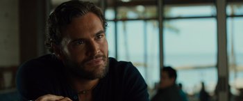 Movie still from “Snatched” (2017), directed by Jonathan Levine – A person with a beard looking at the camera; Close Up shot, Over the shoulder angle