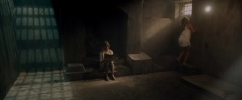 Movie still from “Snatched” (2017), directed by Jonathan Levine – A woman sitting on steps reading a book; Wide shot, High angle