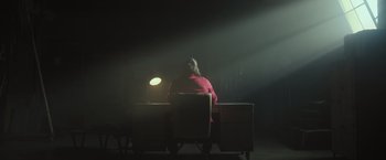 Movie still from “Snatched” (2017), directed by Jonathan Levine – A person sitting at a desk in a dark room; Extreme Wide shot, Low angle