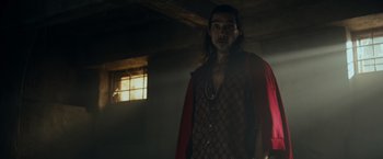 Movie still from “Snatched” (2017), directed by Jonathan Levine – A man standing in a room with a light shining on him; Medium shot, Low angle