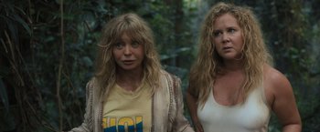 Movie still from “Snatched” (2017), directed by Jonathan Levine – Two women standing next to each other in the woods; Close Up shot, Over the shoulder angle