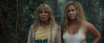 Movie still from “Snatched” (2017), directed by Jonathan Levine – Two women standing next to each other in the woods; Close Up shot, High angle